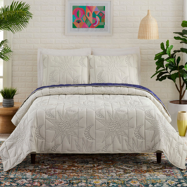 Boho celestial sun and moon quilt set in queen size with astrological pattern on bed